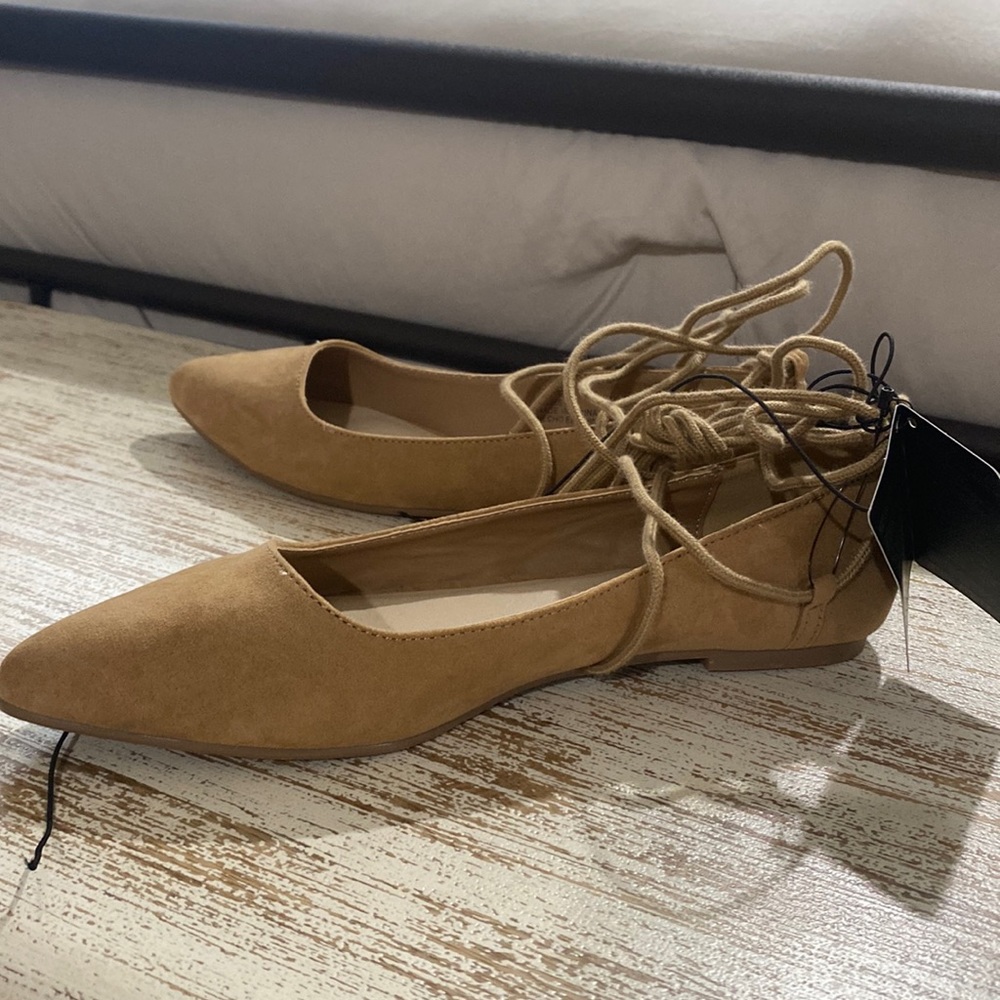 Tan flats with tie up the leg laces